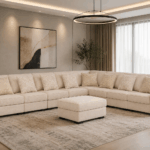 Brancaster beige corner sofa with decorative cushions and matching upholstered ottoman in a modern living room
