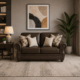 Nancy 2 Seater Sofa in Brown with rolled arms, decorative cushions and nailhead trim