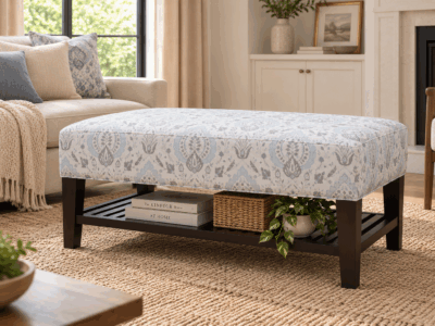 Torrent ottoman with patterned upholstered top, dark wooden frame and lower storage shelf