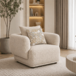 Alto single sofa in beige with rounded arms and decorative cushions