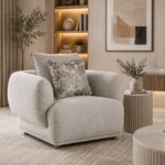 Alto single sofa in grey with rounded arms and decorative cushions