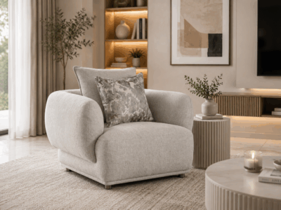 Alto single sofa in grey with rounded arms and decorative cushions