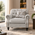 Keensburg single sofa in light beige fabric with button tufted back, rolled arms and nailhead detailing