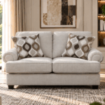 Nettington 2 seater beige fabric sofa with plush cushions and rounded arms
