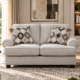Nettington 2 seater beige fabric sofa with plush cushions and rounded arms