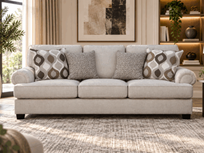 Nettington 3 seater beige fabric sofa with plush cushions and patterned accent pillows