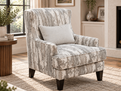 Polar accent chair with grey and white patterned upholstery, lumbar cushion and dark wooden legs