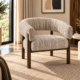 Solara accent chair with curved beige textured upholstery and warm wooden frame